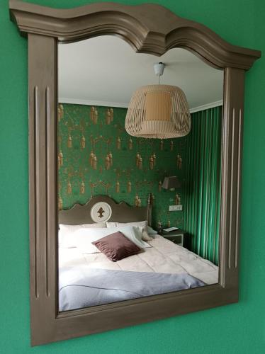 a reflection of a bedroom with a bed in a mirror at Alojamiento Playa de Candás in Candás