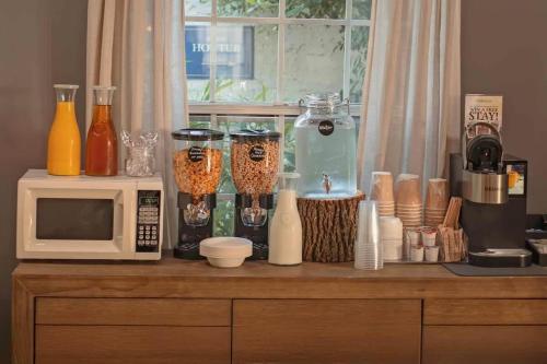 a kitchen counter with a microwave and various items on it at Historic Riverview Inn Suite Ten in Chattanooga