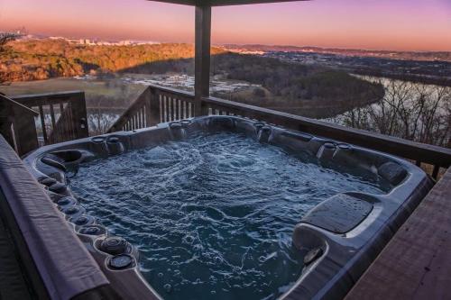 a jacuzzi tub on a deck with a view at Historic Riverview Inn Suite Ten in Chattanooga