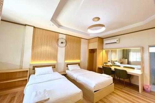 a hospital room with two beds and a desk at BB house & resort in Ban Thum