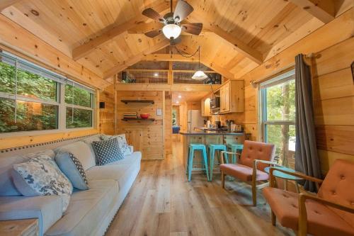 a living room and kitchen in a tiny house at Papa Cabin Tiny Log Home Comfort In Rustic Bliss in Chattanooga