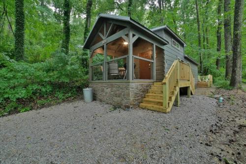 a small cabin in the woods with a large window at Martha Cabin Tiny Cabin By Downtown Chattanooga in Chattanooga