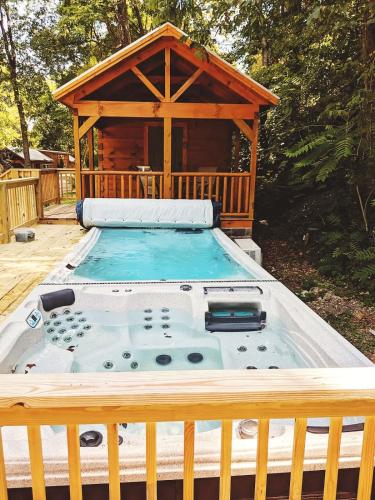 a hot tub on a deck with a gazebo at Bryce Cabin Lookout Mtn Tiny Home W Swim Spa in Chattanooga