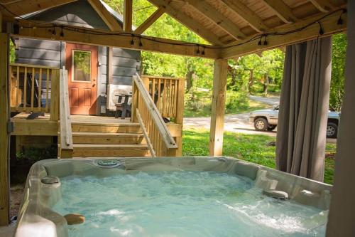 a hot tub in the backyard of a house at Meg Cabin Tiny Rustic Comfort On Lookout Mtn in Chattanooga