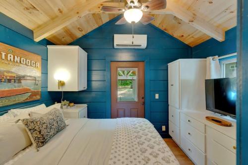 a blue bedroom with a bed and a tv at Pops Cabin Lookout Mountain Luxury Tiny Home in Chattanooga