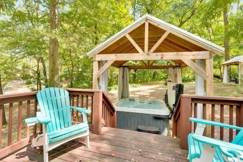 a wooden deck with two chairs and a gazebo at Pops Cabin Lookout Mountain Luxury Tiny Home in Chattanooga