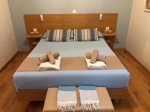 a bedroom with a bed with towels on it at Lemonaki House Lefkada in Asprogerakata