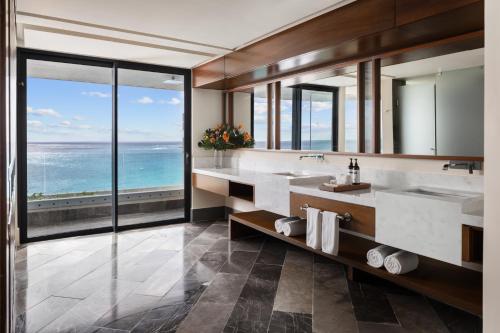 a bathroom with two sinks and a view of the ocean at Secrets Mirabel Cancún Resort & Spa - Adults Only - New Spa now open! in Cancún
