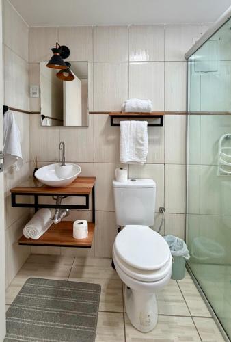 a bathroom with a toilet and a sink at Barriga Verde in Florianópolis