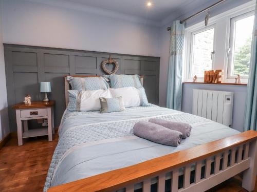 a bedroom with a large bed with two pillows on it at 2 Rock View in Settle