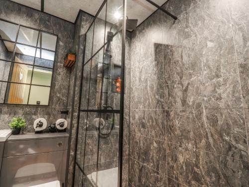 a bathroom with a shower and a sink at 2 Rock View in Settle