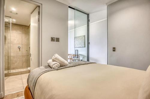 a bedroom with a large bed and a shower at Caica Executives at Ellipes 4202 in Midrand