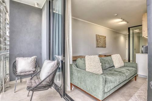 a living room with a green couch and two chairs at Caica Executives at Ellipes 4202 in Midrand