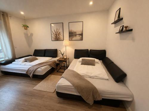 a room with two beds and a table in it at Heide-deluxe in Soltau
