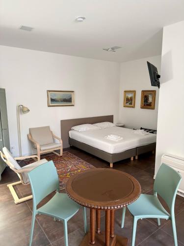 a room with a bed and chairs and a table at Ai Priori in Gemona del Friuli