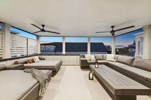 a large living room with couches and a balcony at New Luxury Home Heated Pool & Spa in New Orleans