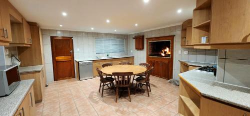 a kitchen with a table and chairs in it at House Magriet in Doring Bay