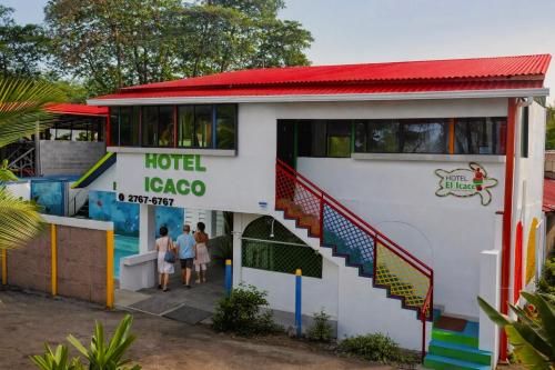 a hotel igoco with people walking in front of it at Hotel El Icaco Tortuguero in Tortuguero