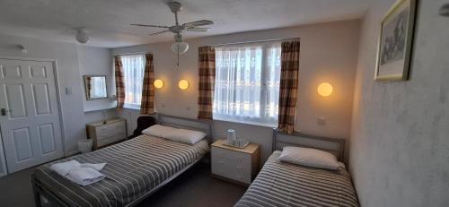 En eller flere senger på et rom på Malvern Hotel