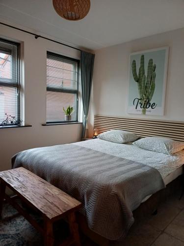a bedroom with a bed with a cactus on the wall at De Allerhof in Hattem