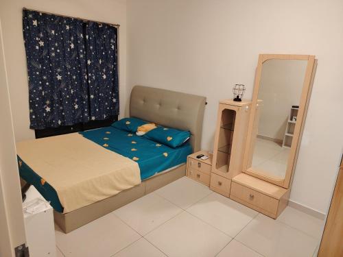 a small bedroom with a bed and a mirror at Habitus in Shah Alam