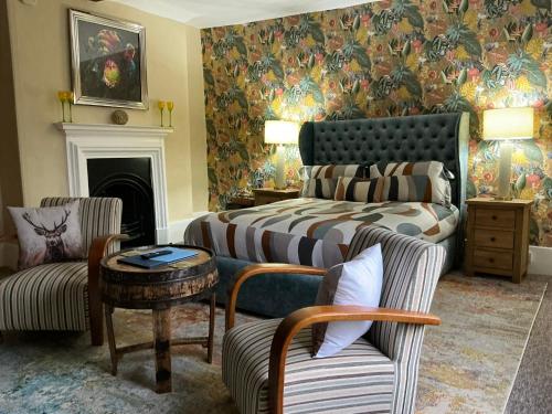 a living room with a bed and a couch at Rorrington Hall in Chirbury