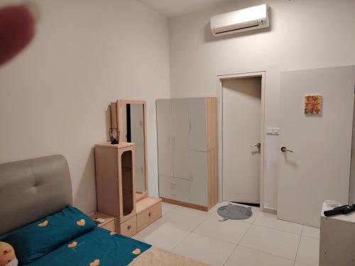 a living room with a bed and a closet at Habitus in Shah Alam