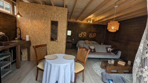 a living room with a table and a couch at Bungalow TRADICIONS en FincaReal in Negreira