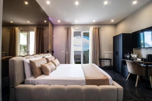 a bedroom with a large bed with a couch at My Place B&B in Carini