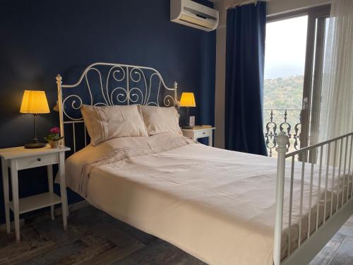 a bedroom with a white bed with a window at Ayda Bağları Winery & Vineyards in Seferihisar