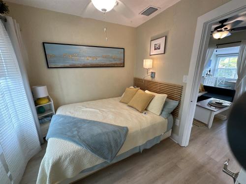 a bedroom with a bed and a painting on the wall at Sunny PaG Island rental wbikes-just steps2beach in St. Pete Beach