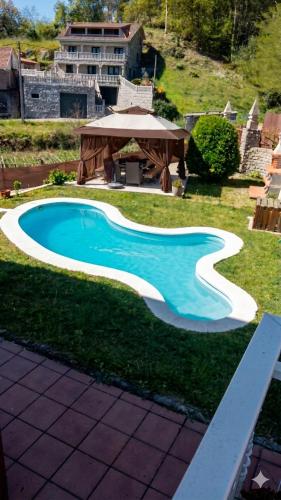 a swimming pool in a yard with a gazebo at A Casa Do Viso Do Chirin in Ponteareas