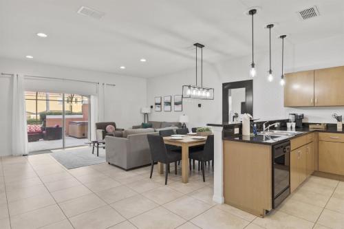 a kitchen and living room with a table and a couch at Near Disney Private Hot Tub April Deal in Kissimmee