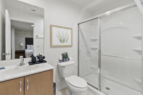 a bathroom with a shower and a toilet and a sink at Near Disney Private Hot Tub April Deal in Kissimmee