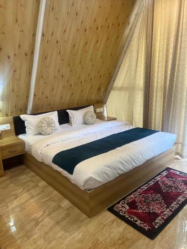 a bedroom with a large bed with a window at thesukoon in Bhīm Tāl