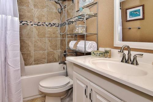 a bathroom with a toilet and a sink and a shower at Belleair Beach Club 315 in Clearwater Beach