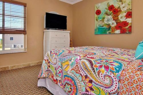 a bedroom with a bed and a flat screen tv at Belleair Beach Club 315 in Clearwater Beach