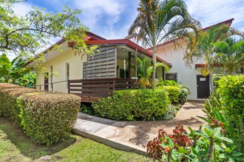 a house with a palm tree and bushes at Modern Villa with Pool & Garden in Farehau