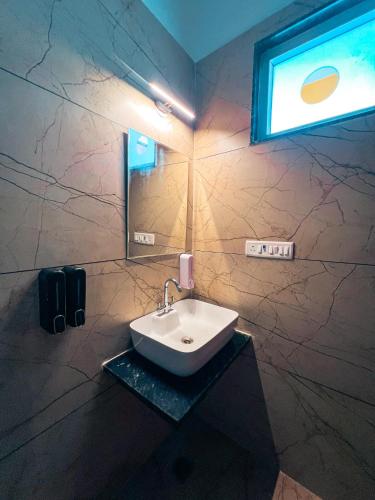 a white sink in a bathroom with a window at Bingo Service Apartment Grand 3BHK in Alwar