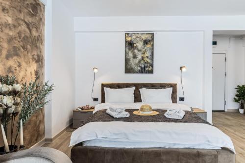 a bedroom with a large bed with a hat on it at Sea Reflections in Infinity Pool & Spa Resort in Mamaia Sat/Năvodari