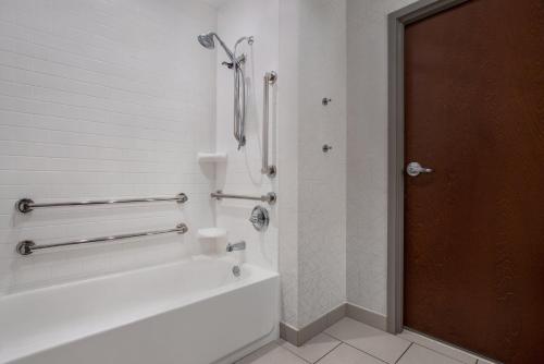 a white bathroom with a tub and a shower at Holiday Inn Express & Suites Terre Haute by IHG in Terre Haute