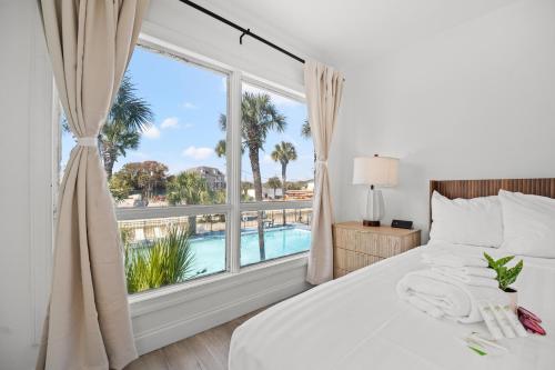 a bedroom with a bed and a large window at Sun Fun in Myrtle Beach