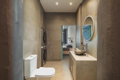 a bathroom with a toilet and a sink and a mirror at Rada Residence in Livadi