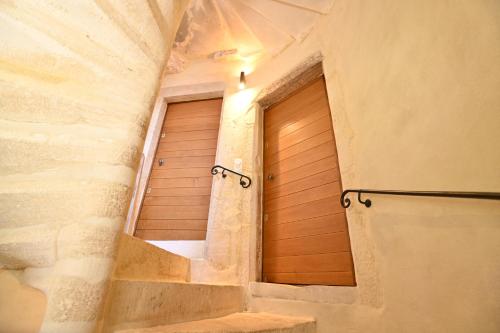 a staircase with a wooden door in a room at Chambres d'hôtes de La Tour Morillon in Saint-Amand-Montrond