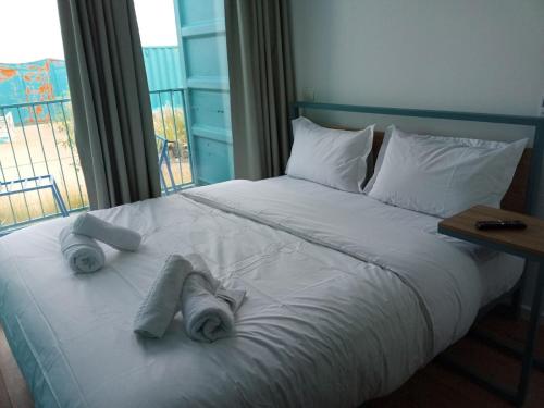 a bedroom with a bed with towels on it at Oxygen Village in Zeïda