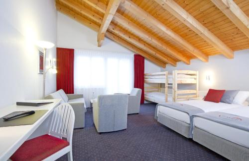 Postel nebo postele na pokoji v ubytování Hotel Steinmattli