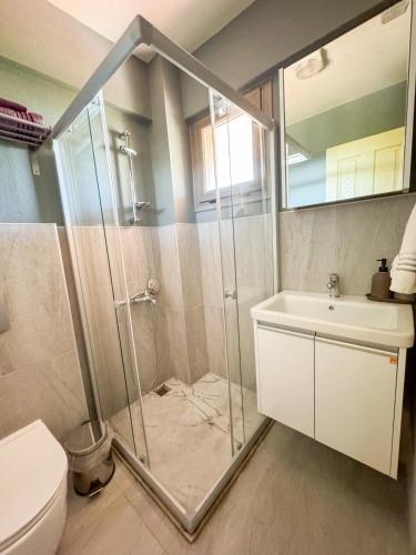 a bathroom with a shower and a sink and a toilet at Ayda Bağları Winery & Vineyards in Seferihisar