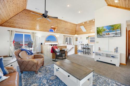 a living room with a couch and a table at 5066 - McBride's Shore Thing 2 in Kill Devil Hills