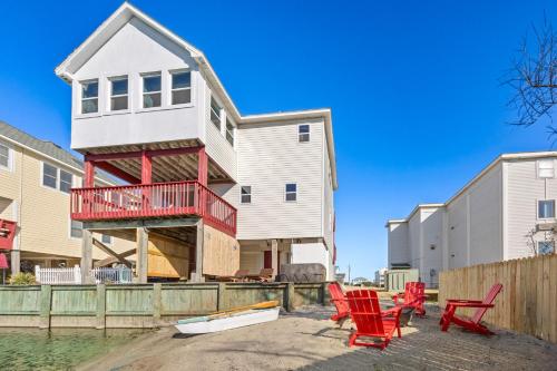 a house on the water with red chairs at 5066 - McBride's Shore Thing 2 in Kill Devil Hills