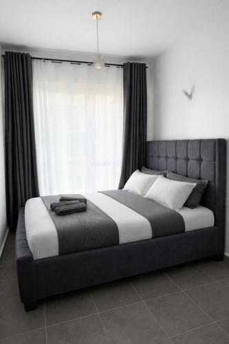 a bed in a bedroom with a large window at The Cozy Cube at Tsavo Sunset in Nairobi